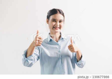 Asian woman rejoicing, looking happy, champion, fist pump gesture, standing over white background. young woman had happy, positive expression on her face, highlighted by bright smile. Asian woman rejoicing, looking happy, champion, fist pump gesture, standing over white background. young woman had happy, positive expression on her face, highlighted by bright smile. 130677866