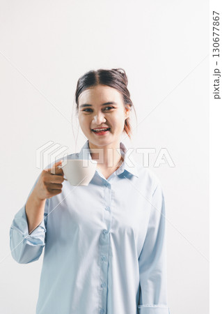 Asian woman rejoicing, looking happy, champion, fist pump gesture, standing over white background. young woman had happy, positive expression on her face, highlighted by bright smile. Asian woman rejoicing, looking happy, champion, fist pump gesture, standing over white background. young woman had happy, positive expression on her face, highlighted by bright smile. 130677867
