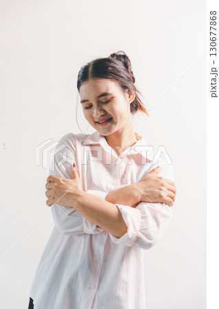 Asian woman rejoicing, looking happy, champion, fist pump gesture, standing over white background. young woman had happy, positive expression on her face, highlighted by bright smile. Asian woman rejoicing, looking happy, champion, fist pump gesture, standing over white background. young woman had happy, positive expression on her face, highlighted by bright smile. 130677868