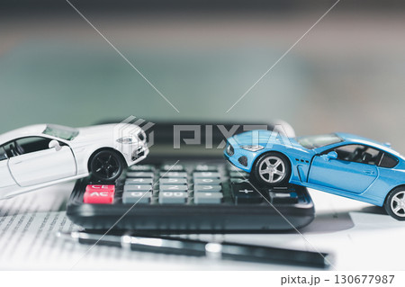Client legal contract and finance document for business deal involving vehicle, agreements cover car loan, insurance, investment terms, with car key handed over to complete transaction. Client legal contract and finance document for business deal involving vehicle, agreements cover car loan, insurance, investment terms, with car key handed over to complete transaction. 130677987