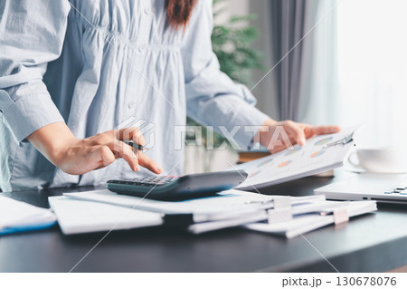 Business woman analyze calculate company financial, tax results office accounting statistics analytical research. calculating business balance prepare tax reduction. Tax deduction planning concept. Business woman analyze calculate company financial, tax results office accounting statistics analytical research. calculating business balance prepare tax reduction. Tax deduction planning concept. 130678076