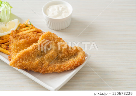 fish and chips - fried fish fillet with potatoes chips 130678229