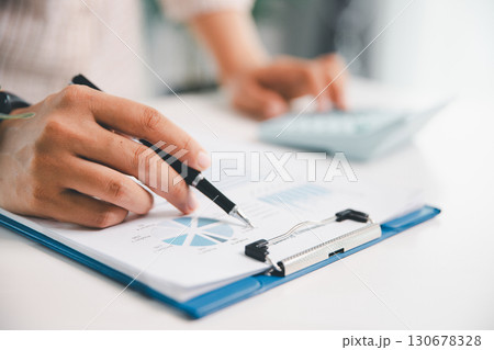 Businesswoman analysis with financial data, marketing business strategy project, Business financing accounting banking concept, finances, calculate about cost to real estate investment, tax system. Businesswoman analysis with financial data, marketing business strategy project, Business financing accounting banking concept, finances, calculate about cost to real estate investment, tax system. 130678328