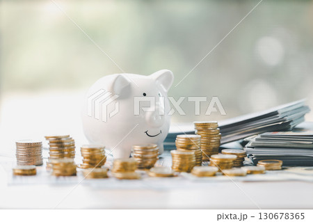 Money box filled with coins, saving cash, banking wisely, making sound investments can build financial wealth, personal finance and overall economy through proper business and currency management. 130678365