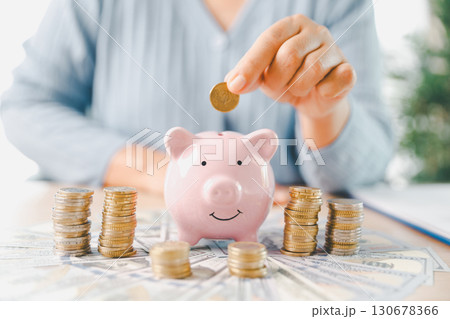 Businesswoman focused on saving money, smart financial planning, using banking, investment strategies to grow business, build wealth, achieve success while contributing to overall economy growth. Businesswoman focused on saving money, smart financial planning, using banking, investment strategies to grow business, build wealth, achieve success while contributing to overall economy growth. 130678366