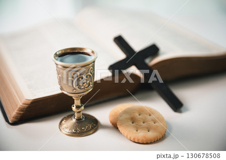 Christianity, holy communion ceremony is sacred act of worship and faith, where bread and wine in chalice symbolize body and blood of Christ in the religious eucharist tradition. Christianity, holy communion ceremony is sacred act of worship and faith, where bread and wine in chalice symbolize body and blood of Christ in the religious eucharist tradition. 130678508