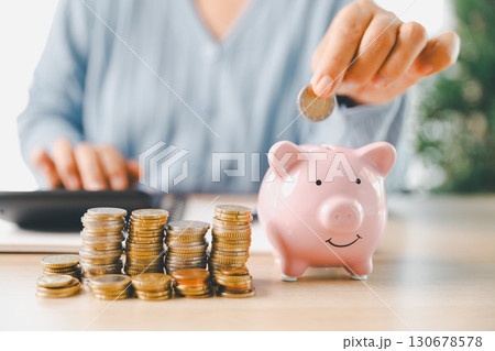 Businesswoman focused on saving money, smart financial planning, using banking, investment strategies to grow business, build wealth, achieve success while contributing to overall economy growth. 130678578