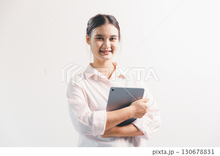Asian woman rejoicing, looking happy, champion, fist pump gesture, standing over white background. young woman had happy, positive expression on her face, highlighted by bright smile. Asian woman rejoicing, looking happy, champion, fist pump gesture, standing over white background. young woman had happy, positive expression on her face, highlighted by bright smile. 130678831
