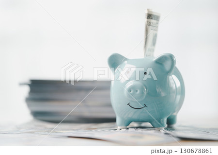 Money box filled with coins, saving cash, banking wisely, making sound investments can build financial wealth, personal finance and overall economy through proper business and currency management. 130678861