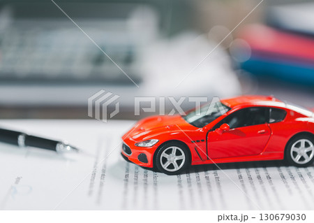 Client legal contract and finance document for business deal involving vehicle, agreements cover car loan, insurance, investment terms, with car key handed over to complete transaction. 130679030
