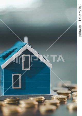 House model placed beside money coins illustrates concept of saving and financial planning for buying home, highlighting investment, mortgage options, home loans, refinancing, smart finance strategies 130679101