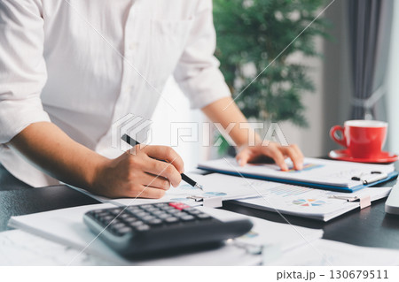 Business woman analyze calculate company financial, tax results office accounting statistics analytical research. calculating business balance prepare tax reduction. Tax deduction planning concept. 130679511