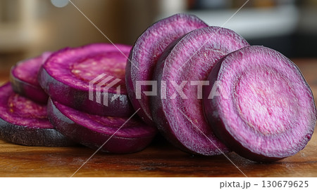 Purple beetroot slices arranged on wooden surface, fresh organic vegetable for healthy cooking and nutritional recipes Purple beetroot slices arranged on wooden surface, fresh organic vegetable for healthy cooking and nutritional recipes 130679625