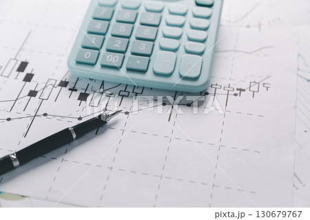 Auditor reviews financial statement and balance sheet on desk using a calculator, representing the concept of accounting, audit, and finance in preparing a detailed financial report for the business. 130679767