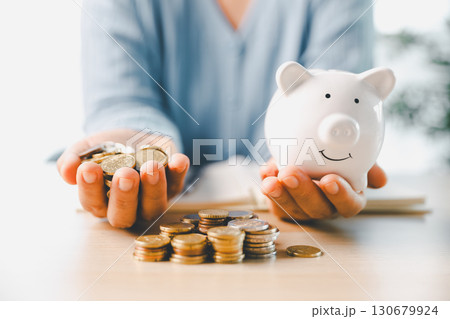 Businesswoman focused on saving money, smart financial planning, using banking, investment strategies to grow business, build wealth, achieve success while contributing to overall economy growth. Businesswoman focused on saving money, smart financial planning, using banking, investment strategies to grow business, build wealth, achieve success while contributing to overall economy growth. 130679924