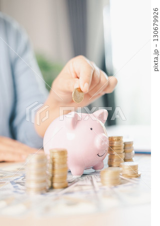 Hand holding coin symbolizes saving, investment, smart finance decisions money, currency, cash financial wealth, driving business growth, economic stability, long-term success in banking economy. 130679926