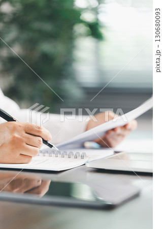 Finance bank tax expense accounting budget money businessman hand use calculator Financial calculate accountant close up calculator with graph chart write office desk Business expense analysis saving 130680093