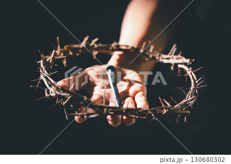 Crucifixion of Jesus Christ, nail-pierced hands, crown of thorns, cross, symbol of Christianity, representing holy sacrifice, passion, faith central to Easter celebration, religious tradition. 130680302