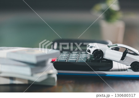 Client legal contract and finance document for business deal involving vehicle, agreements cover car loan, insurance, investment terms, with car key handed over to complete transaction. 130680317