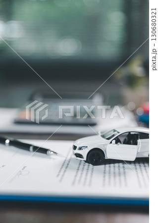 Car loan approval concept. Client finalizes purchase of vehicle by signing contract includes auto loan, insurance, credit terms, making car smart financial investment business-backed finance option. 130680321