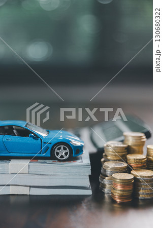 Euro car finance. car with calculator and money on wood table. insurance concept. investment and wealth accumulation through the symbolism of miniature car alongside coins. 130680322
