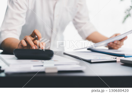 Business woman analyze calculate company financial, tax results office accounting statistics analytical research. calculating business balance prepare tax reduction. Tax deduction planning concept. 130680420