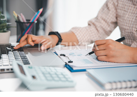 Businesswoman analysis with financial data, marketing business strategy project, Business financing accounting banking concept, finances, calculate about cost to real estate investment, tax system. Businesswoman analysis with financial data, marketing business strategy project, Business financing accounting banking concept, finances, calculate about cost to real estate investment, tax system. 130680440