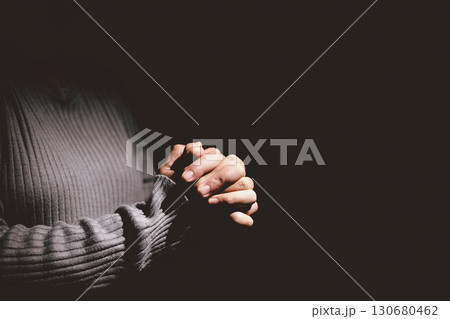 Person clasping hands in prayer, symbolizing faith, hope, spirituality, devotion, inner strength, meditation, belief, healing and the power of trust during difficult times in life. 130680462