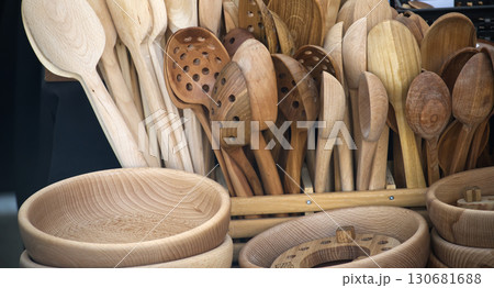 Collection of handcrafted wooden spoons and bowls showcases rustic charm and artisanal craftsmanship 130681688