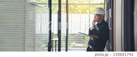 Man construction engineer writing note wear blue shirt safety white hard hat at construction site. Industry labour male worker. Architecture man drawing engineer civil constrcution real estate 130681742