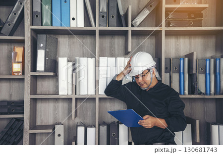Man construction engineer writing note wear blue shirt safety white hard hat at construction site. Industry labour male worker. Architecture man drawing engineer civil constrcution real estate 130681743
