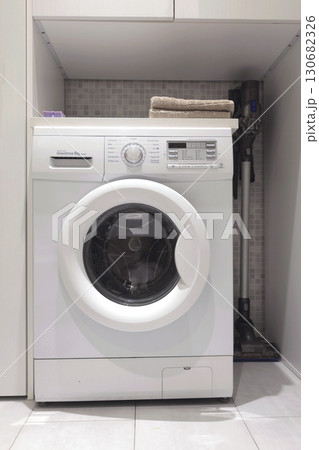 Laundry room in house. Washing machine and linen storage cabinet. Cleanliness and lifestyle. Activities, house cleaning. Laundry room in house. Washing machine and linen storage cabinet. Cleanliness and lifestyle. Activities, house cleaning. 130682326
