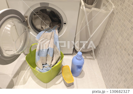 Laundry room in house. Washing machine and linen storage cabinet. Cleanliness and lifestyle. Activities, house cleaning. Laundry room in house. Washing machine and linen storage cabinet. Cleanliness and lifestyle. Activities, house cleaning. 130682327