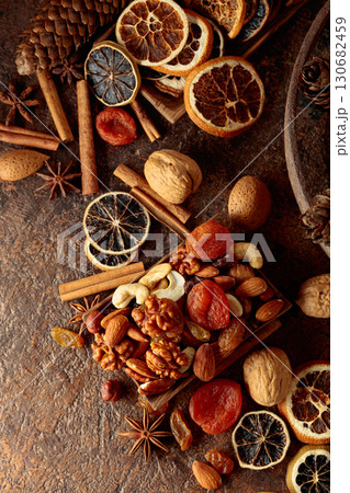 Dried fruits and nuts on a brown vintage background. Dried fruits and nuts on a brown vintage background. 130682459
