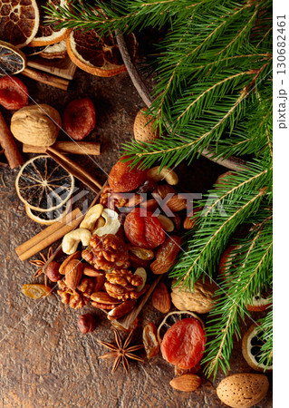 Dried fruits and nuts on a brown vintage background. 130682461