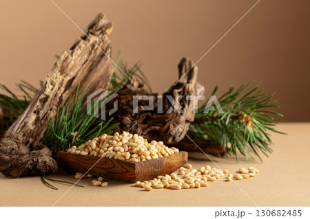 Peeled pine nuts with cedar snags and green branches. Peeled pine nuts with cedar snags and green branches. 130682485