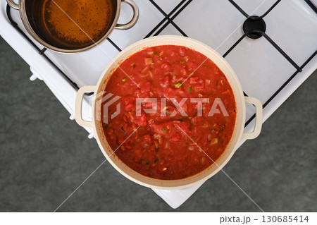 Cooking tomato and bread soup on a stove Cooking tomato and bread soup on a stove 130685414