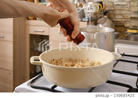 Cooking noodles with mushrooms in a cozy kitchen during the afternoon Cooking noodles with mushrooms in a cozy kitchen during the afternoon 130685425