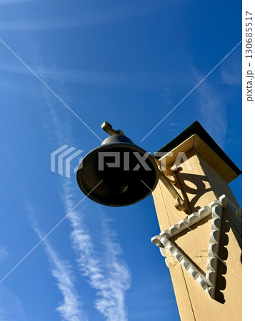 A bell against a bright blue sky. High quality photo A bell against a bright blue sky. High quality photo 130685517