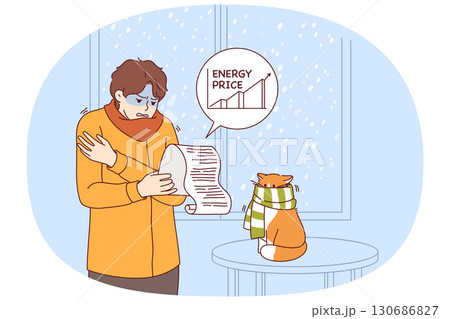 Rising prices for electricity cause stress for man studying bill, standing in cold apartment Rising prices for electricity cause stress for man studying bill, standing in cold apartment 130686827