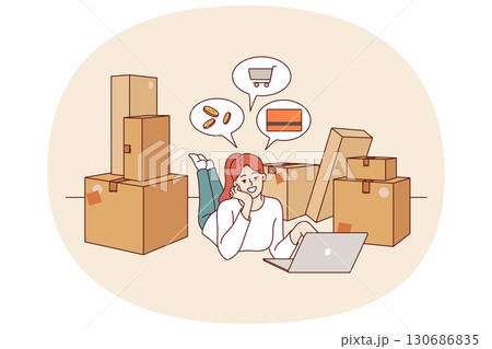 Woman owner online store is engaged in e-commerce, lying on floor with laptop among cardboard boxes Woman owner online store is engaged in e-commerce, lying on floor with laptop among cardboard boxes 130686835