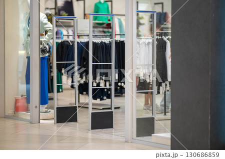 Radio-frequency security gates with integrated metal detector at a clothing store entrance 130686859