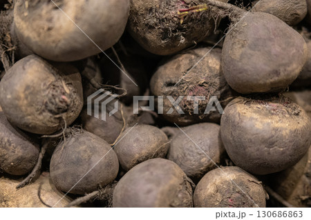 Red beet roots scattered on a market counter. Red beet roots scattered on a market counter. 130686863