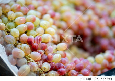 Ripe green grapes on a store counter Ripe green grapes on a store counter 130686864