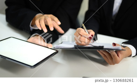 Businesswomen working together with digital tablet and discussing reports and strategy 130688261