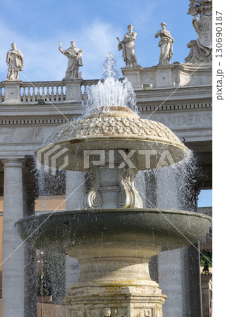 Rome, Italy - August 17, 2019: Fountain on St. Peter's Square in Vatican. Rome, Italy - August 17, 2019: Fountain on St. Peter's Square in Vatican. 130690187
