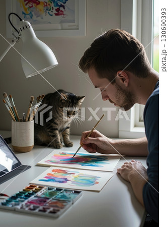 Artist Painting Watercolors in a Minimalist Home Office with a Cat and Natural Light Artist Painting Watercolors in a Minimalist Home Office with a Cat and Natural Light 130690393