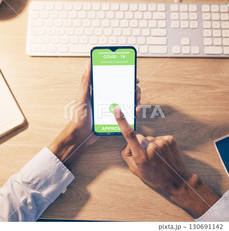 Hands, phone and QR code of covid vaccination for online passport, travel or business trip at night by office desk. Hand of employee holding smartphone with approved verification for traveling Hands, phone and QR code of covid vaccination for online passport, travel or business trip at night by office desk. Hand of employee holding smartphone with approved verification for traveling 130691142