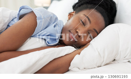 Sleep, relax and black woman in bed, pillow and blanket for dreaming, sleeping and comfortable at home. Morning, bedroom and closeup of tired person with eyes closed for resting, peace and cozy 130691193