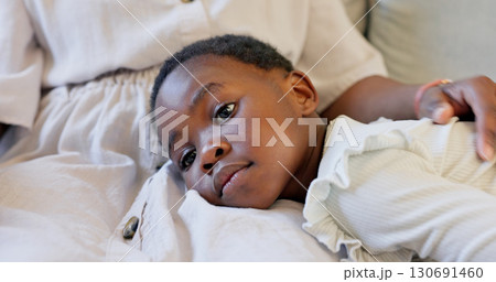 Family, mother and child at a home bonding and showing love while relaxing together on living room sofa. Black woman with girl kid lying on lap with happiness, care and support in South Africa. Family, mother and child at a home bonding and showing love while relaxing together on living room sofa. Black woman with girl kid lying on lap with happiness, care and support in South Africa. 130691460